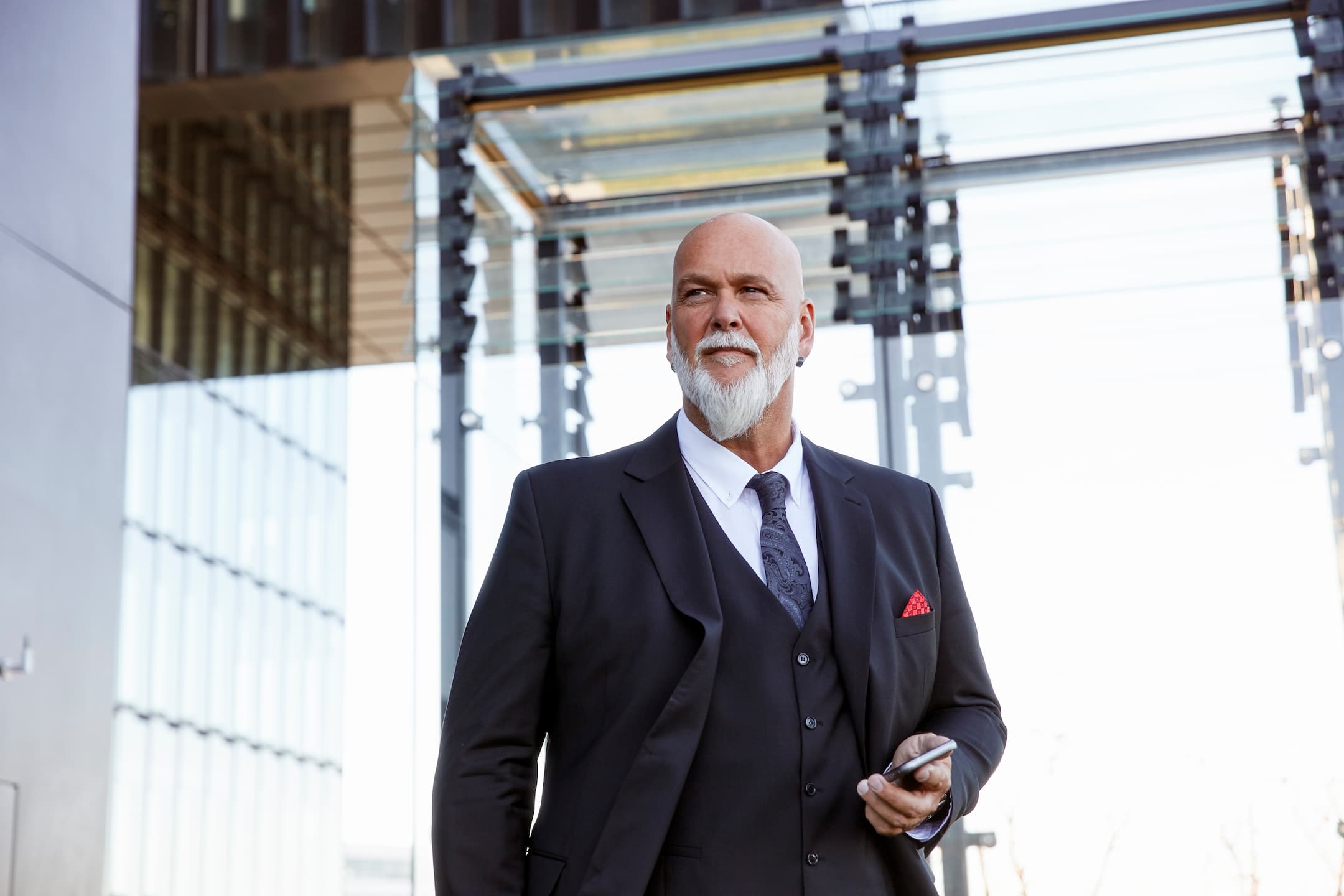 elegant-businessman-using-smartphone-in-the-city-2024-09-15-22-11-58-utc